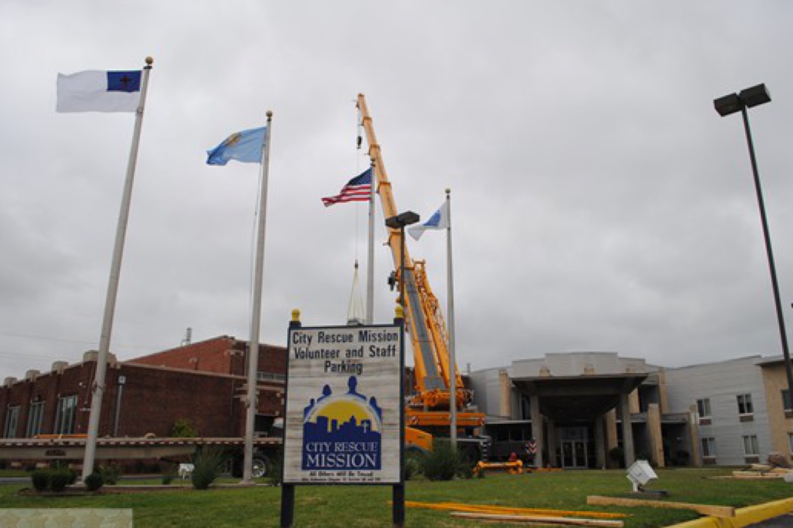 Crane setting a rooftop air handling unit