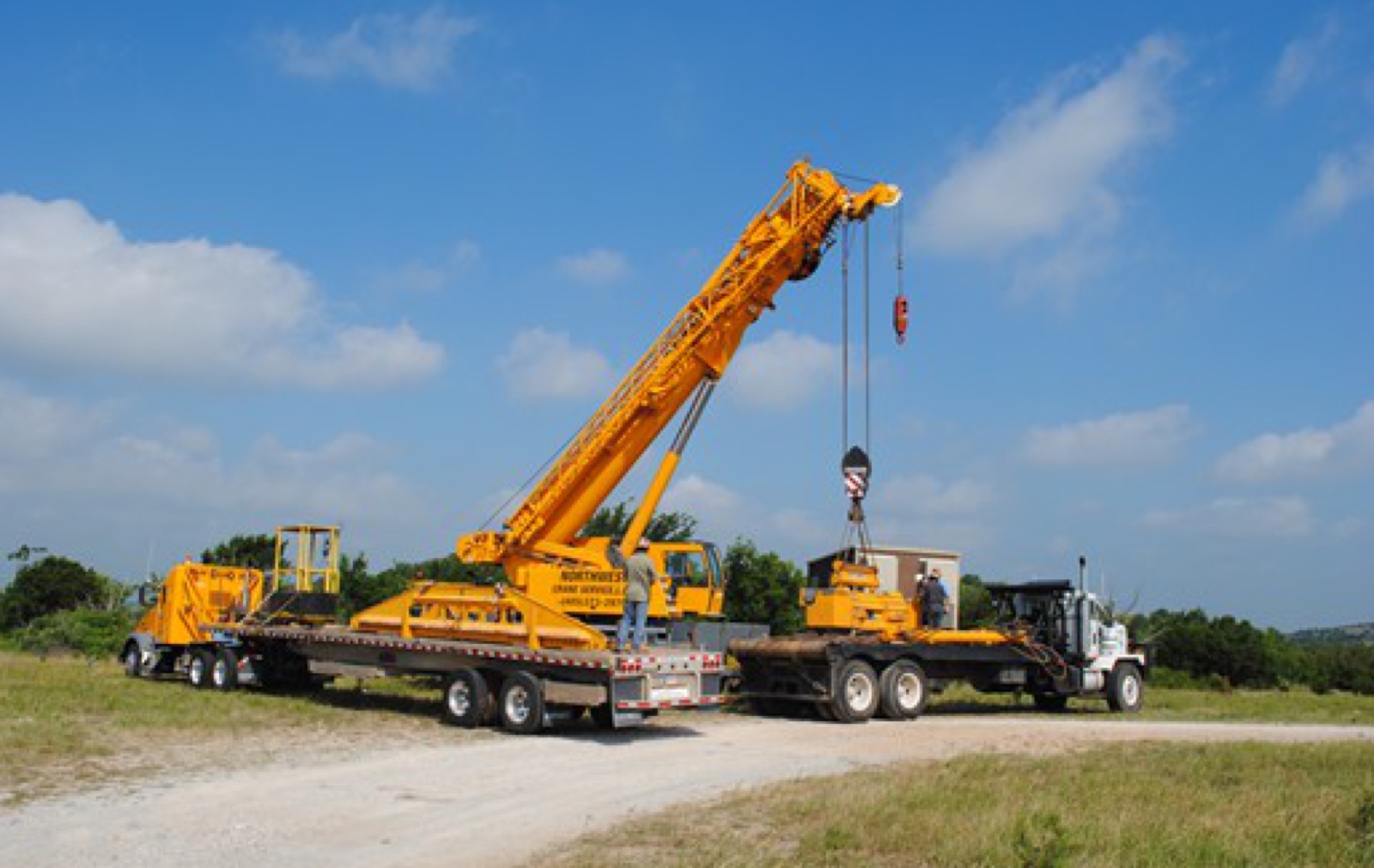 Crane setting a cellular equipment building